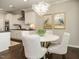 Bright dining area featuring a modern light fixture, tasteful artwork, and dark hardwood floors at 725 Banningford Rd, Cary, NC 27518