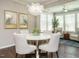 Cozy dining room with a modern chandelier, comfortable chairs, and ample natural light at 725 Banningford Rd, Cary, NC 27518