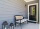 Inviting front porch with a cozy bench, decorative lanterns, and a stylish front door at 725 Banningford Rd, Cary, NC 27518