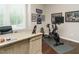 Bright home office with large desk, exercise bike, and artwork at 725 Banningford Rd, Cary, NC 27518
