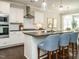 Bright kitchen with white cabinets, stainless appliances, and a large island with bar seating at 725 Banningford Rd, Cary, NC 27518