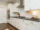 Well-lit kitchen showcasing white cabinets, a gas cooktop, and dark countertops at 725 Banningford Rd, Cary, NC 27518