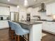 Stylish kitchen with stainless steel appliances, white cabinets, and a dark countertop island with seating at 725 Banningford Rd, Cary, NC 27518