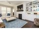 Bright living room with a fireplace, built-in shelving, and comfortable seating at 725 Banningford Rd, Cary, NC 27518