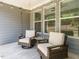 Cozy screened-in porch with comfortable chairs and string lights at 725 Banningford Rd, Cary, NC 27518