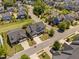 Panoramic aerial shot of a planned community, boasting lush landscaping, a central pond, and sidewalks at 7700 Stonehenge Farm Ln, Raleigh, NC 27613