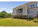 Exterior shows a raised wooden deck and screened in porch in the backyard of the property at 7700 Stonehenge Farm Ln, Raleigh, NC 27613