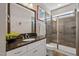 Elegant bathroom featuring dark granite counters, and glass-enclosed shower at 7700 Stonehenge Farm Ln, Raleigh, NC 27613