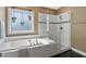Spa-like bathroom with soaking tub and glass enclosed shower at 7700 Stonehenge Farm Ln, Raleigh, NC 27613