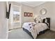 Cozy bedroom featuring a queen-size bed, window and television at 7700 Stonehenge Farm Ln, Raleigh, NC 27613