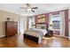 Spacious bedroom boasts natural light, hardwood flooring, and ample closet space at 7700 Stonehenge Farm Ln, Raleigh, NC 27613