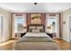 Bright bedroom with hardwood floors, comfortable bed, and coordinated decor at 7700 Stonehenge Farm Ln, Raleigh, NC 27613