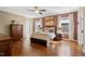 Primary bedroom showcasing hardwood floors, and bright windows at 7700 Stonehenge Farm Ln, Raleigh, NC 27613