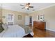 Bedroom with hardwood floors, light-colored walls, and walk-in bathroom at 7700 Stonehenge Farm Ln, Raleigh, NC 27613