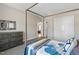 A neutral bedroom with a decorative mirror and grey dresser at 7700 Stonehenge Farm Ln, Raleigh, NC 27613