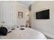 Bedroom features a decorative bedspread, and mounted television at 7700 Stonehenge Farm Ln, Raleigh, NC 27613