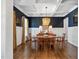 Charming dining room with a coffered ceiling, hardwood floors, and designer paint on the walls at 7700 Stonehenge Farm Ln, Raleigh, NC 27613