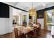 Elegant dining room with navy accent walls, coffered ceilings, and a stylish pendant light at 7700 Stonehenge Farm Ln, Raleigh, NC 27613