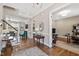 Open floorplan with hardwood floors, staircase, and views into the dining room and living room at 7700 Stonehenge Farm Ln, Raleigh, NC 27613