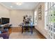 Bright home office features hardwood floors, large windows, and an elegant workspace at 7700 Stonehenge Farm Ln, Raleigh, NC 27613