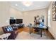 Spacious home office featuring hardwood floors, natural light, and comfortable seating area at 7700 Stonehenge Farm Ln, Raleigh, NC 27613