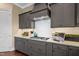 Well-designed kitchen features gray cabinets, ample counter space, and stainless steel appliances at 7700 Stonehenge Farm Ln, Raleigh, NC 27613