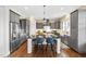 Stylish kitchen featuring a center island with seating, stainless appliances and gray cabinetry at 7700 Stonehenge Farm Ln, Raleigh, NC 27613
