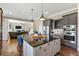 Open concept kitchen featuring a center island with seating, stainless steel appliances, and modern cabinetry at 7700 Stonehenge Farm Ln, Raleigh, NC 27613