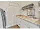 Well-lit laundry room with a countertop, sink, storage, and a modern washer and dryer at 7700 Stonehenge Farm Ln, Raleigh, NC 27613