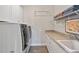 Bright laundry area equipped with a modern washer and dryer, offering convenience at 7700 Stonehenge Farm Ln, Raleigh, NC 27613