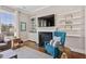Bright living room with a fireplace and large windows, perfect for entertaining or relaxation at 7700 Stonehenge Farm Ln, Raleigh, NC 27613