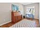 Office space with natural light, hardwood floors and an area rug at 7700 Stonehenge Farm Ln, Raleigh, NC 27613