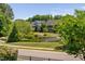 Scenic view of neighborhood pond surrounded by lush landscaping and manicured lawns at 7700 Stonehenge Farm Ln, Raleigh, NC 27613