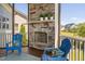 Relaxing screened porch with a stone fireplace, ideal for outdoor entertaining and comfortable seating at 7700 Stonehenge Farm Ln, Raleigh, NC 27613