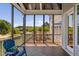 Relax on this screened porch, offering a view of the surrounding landscape and blue sky at 7700 Stonehenge Farm Ln, Raleigh, NC 27613