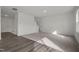 Open concept living space features luxury vinyl plank and carpet flooring, view of stairs and front door at 801 Kenyon Spring Dr, Zebulon, NC 27597