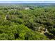 An aerial view reveals the home is surrounded by lush greenery and rolling hills at 8409 Crowder Rd, Raleigh, NC 27603