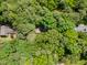 An aerial view shows how the home is surrounded by a beautiful forest at 8409 Crowder Rd, Raleigh, NC 27603