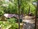 Aerial view of a home with carport and a separate garage, surrounded by lush trees at 8409 Crowder Rd, Raleigh, NC 27603