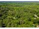 An aerial view shows lush greenery with neighborhood and roads at 8409 Crowder Rd, Raleigh, NC 27603