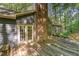 This backyard features a brick chimney, a wooden deck, and french doors at 8409 Crowder Rd, Raleigh, NC 27603