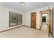 Bright bedroom with carpet, natural light, and wood trim windows, offering a serene and inviting space at 8409 Crowder Rd, Raleigh, NC 27603
