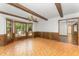 Dining room featuring wood trim, exposed beams, and a bay window at 8409 Crowder Rd, Raleigh, NC 27603