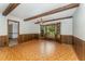 This dining room features wood beams, paneled walls and a large bay window at 8409 Crowder Rd, Raleigh, NC 27603