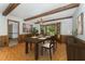 Cozy dining room featuring wood paneling, bay window, and chandelier lighting at 8409 Crowder Rd, Raleigh, NC 27603