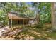 Charming home featuring a convenient carport, lush greenery, and a brick-paved walkway and fenced yard at 8409 Crowder Rd, Raleigh, NC 27603
