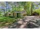 Charming home featuring a lush, wooded lot, a long driveway, and a detached garage at 8409 Crowder Rd, Raleigh, NC 27603