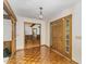 Foyer featuring parquet floors, a decorative light fixture, and an inviting entryway at 8409 Crowder Rd, Raleigh, NC 27603