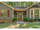 Welcoming front porch with brick steps, a covered entry, and decorative landscaping at 8409 Crowder Rd, Raleigh, NC 27603