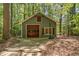 Garage with wood door, window, basketball hoop, and private driveway at 8409 Crowder Rd, Raleigh, NC 27603